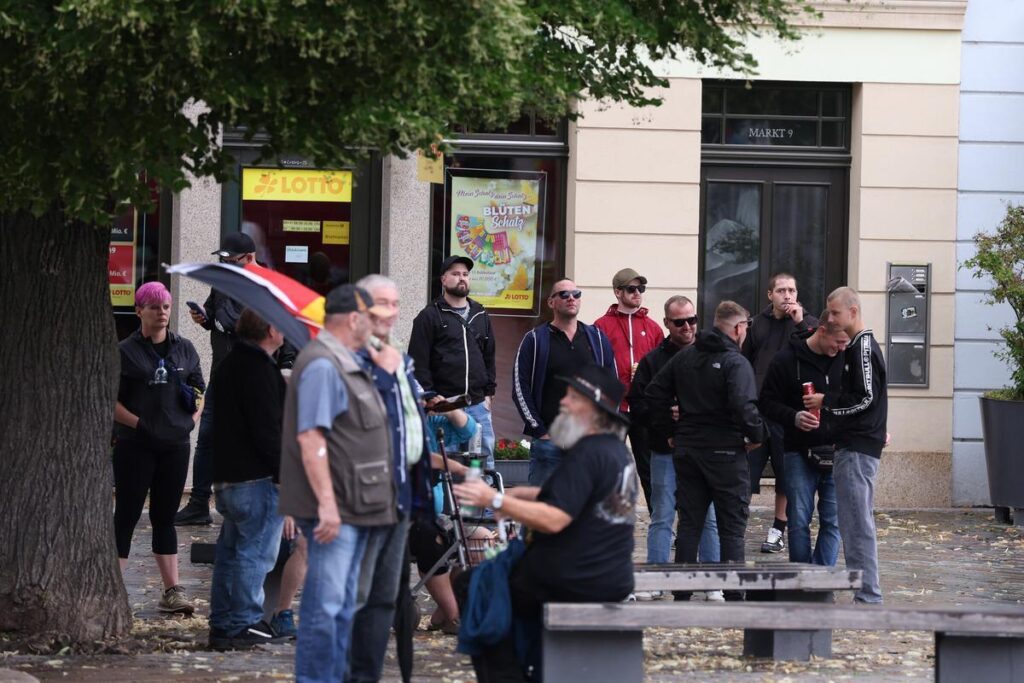 Foto von mehreren Personen, die auf dem Apoldaer Markt bei einer Kundgebung stehen.